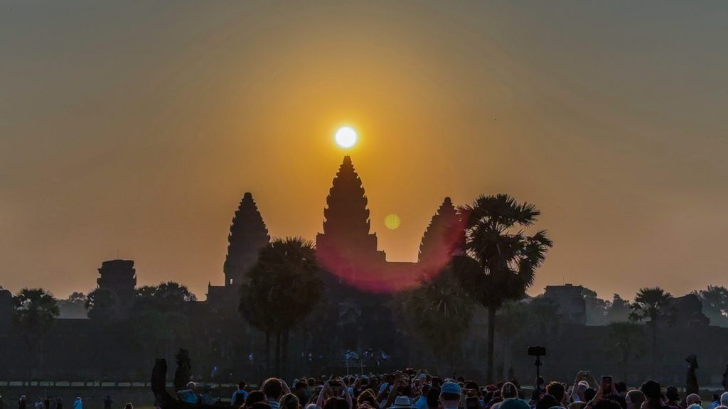 Sunrise over Angkor Wat towers reflected in the sacred pond, Siem Reap